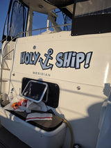 Holy Ship lettering on the transom during installation