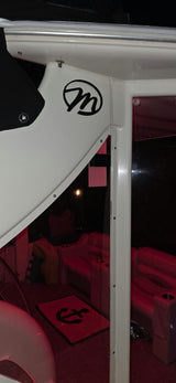 Black circular M emblem on a white hardtop