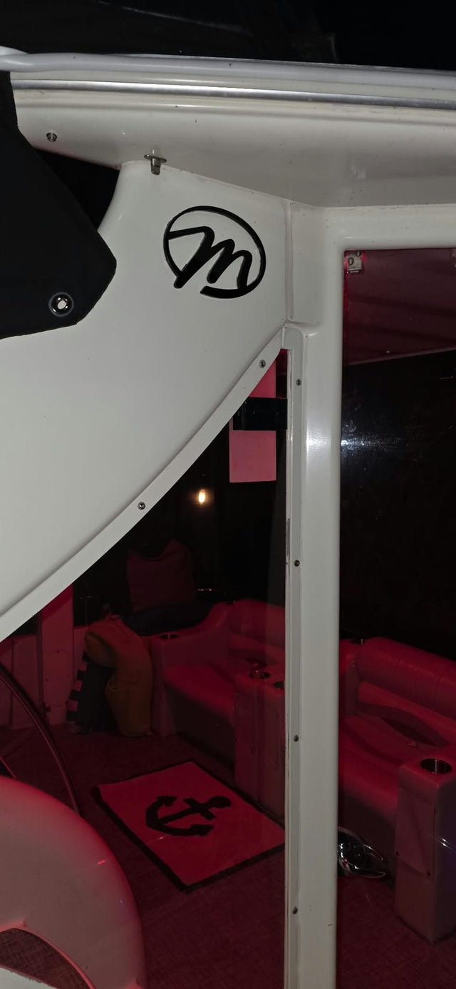 Black circular M emblem on a white hardtop
