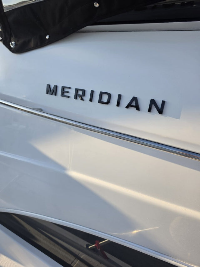 Black dimensional Meridian lettering on a white hull
